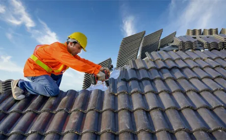 Licensed roofer replacing damaged shingles on an Austin residential home