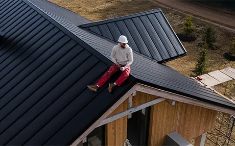 Roofing crew documenting and repairing hail storm damage on residential roof